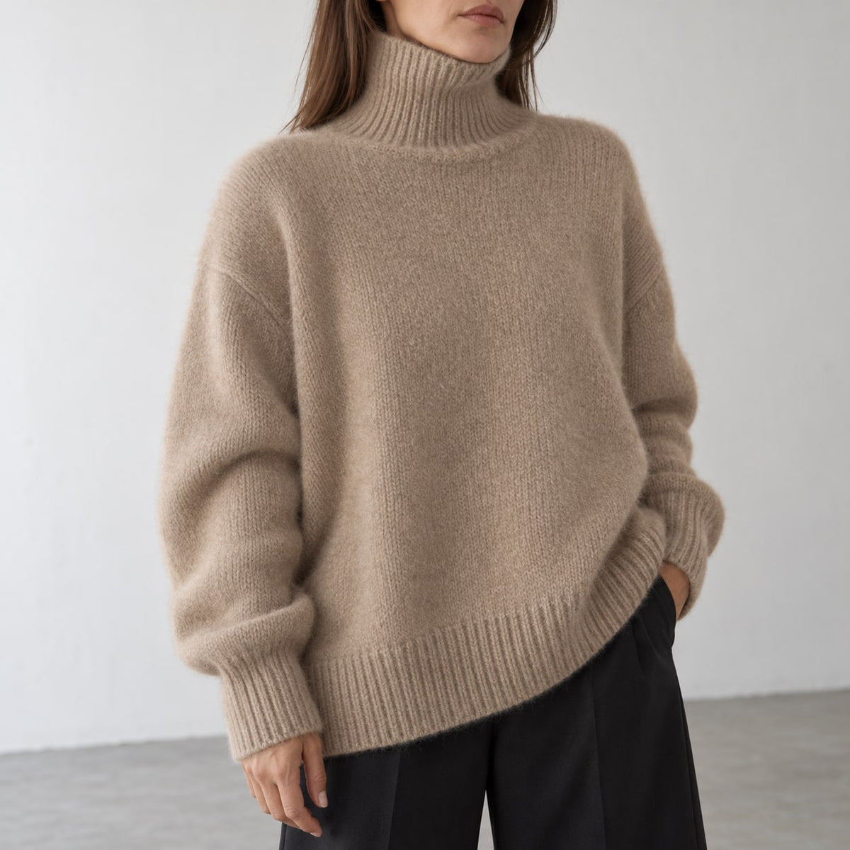 Detalle frontal del jersey oversize de cuello alto camel
