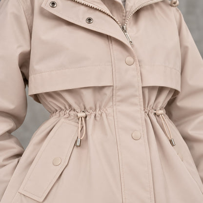 Detalle de cordón de cintura, botones y tejido de parka beige