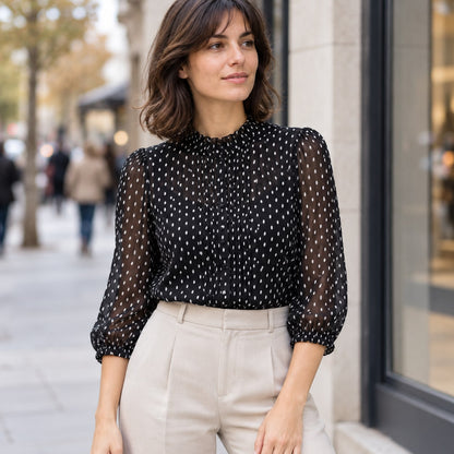 Blusa negra de gasa plumeti con cuello alto en look urbano