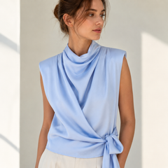 Top de satén azul claro, detalle del cuello drapeado y el lazo